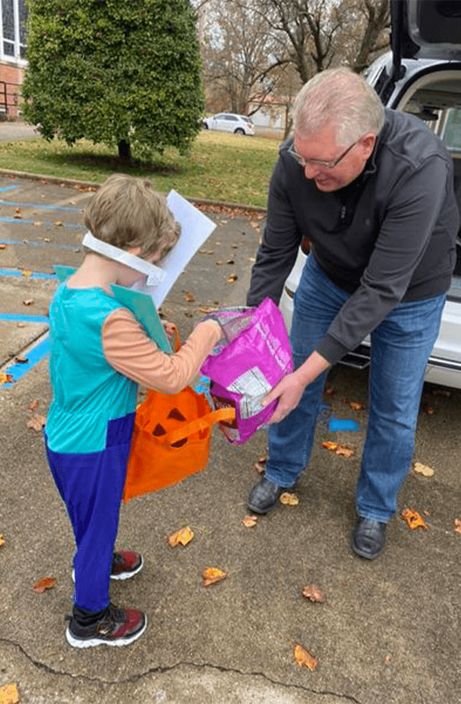 Elder Gentleman Giving Candy to Trick or Treater